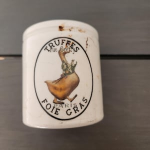 May include: A set of three ceramic mugs with a speckled, matte finish. The mugs are in shades of cream, light gray, and dark gray. Each mug has a simple, minimalist design and a rounded handle.