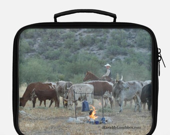 Cowboy herding cattle by a campfire, photo on Lunch Box Tote Bag