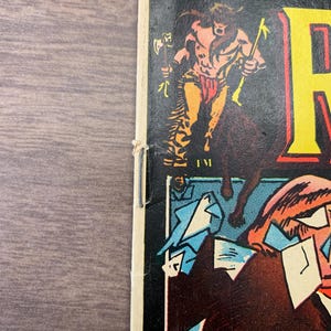 May include: Comic book cover featuring a muscular, shirtless figure with a weapon, atop a horse. The top left corner has the text "1 MAY 20¢". The comic book is titled "R". The image has a vintage, aged appearance.