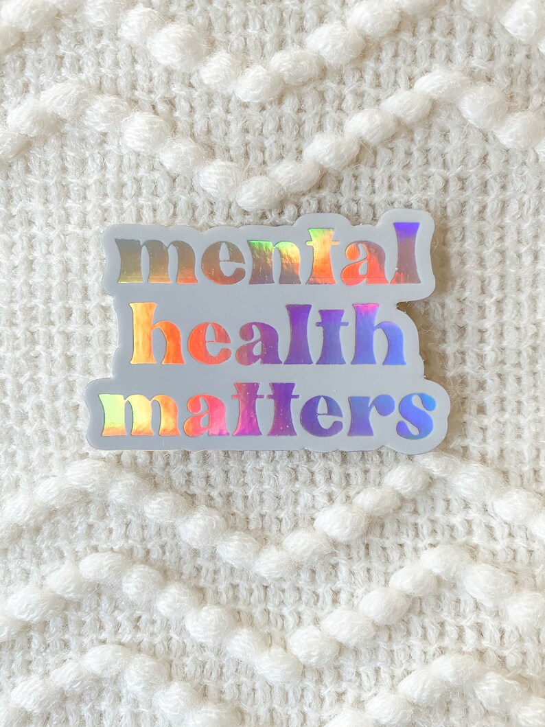 May include: A white sticker with the text "mental health matters" in rainbow iridescent letters.