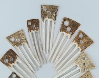 May include: A collection of nine hair combs arranged in a fan shape. Each comb features a textured, brown, mottled top section with circular cutouts and three smooth, white, tapered prongs extending from the base of the decorative head.