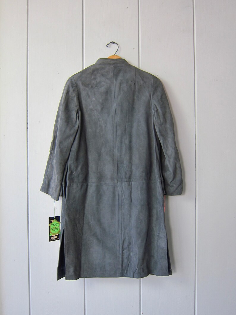 Peut inclure: Un long manteau en daim gris avec un col et une fermeture &agrave; bouton unique. Le manteau porte une &eacute;tiquette "Pellon".