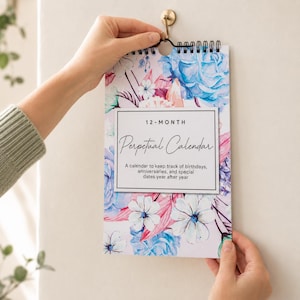 May include: A 12-month perpetual calendar with a spiral binding, featuring a floral pattern of blue, pink, and white flowers. The cover text reads: 12-MONTH Perpetual Calendar. A calendar to keep track of birthdays, anniversaries, and special dates year after year.