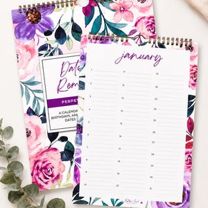 May include: A perpetual date reminder calendar with a floral pattern featuring purple and pink flowers and green leaves. The calendar has a gold wire-o binding and displays the month of January with numbered lines for recording birthdays and events.