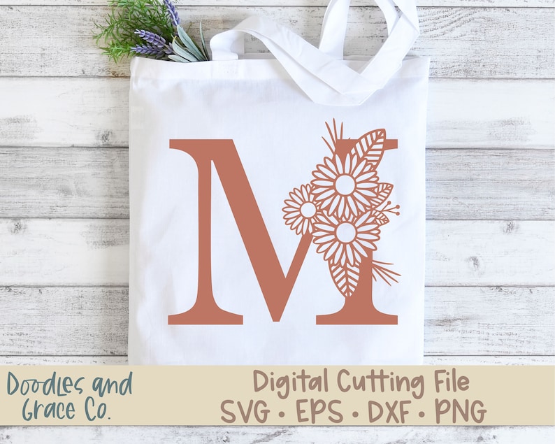 May include: A digital cutting file featuring the letter M with a floral design. The letter is a terracotta color and the flowers are white. The text "Digital Cutting File SVG. EPS. DXF. PNG" is at the bottom of the image.