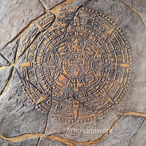 May include: A circular stone-like wall plaque featuring a central Aztec calendar design in raised gold relief against a textured grey background. The surface is divided by deep, gold-filled cracks, and the text Artcreatework is visible.