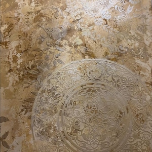 May include: Textured wall art with a beige and brown color palette. The artwork features embossed floral and geometric patterns, including a large circular design in the lower portion. The overall effect is a rustic, vintage aesthetic.