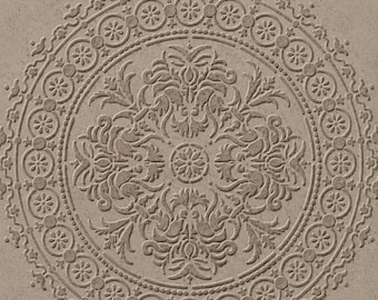 May include: A square tile featuring a circular embossed pattern in a light brown, stone-like finish. The design includes a central floral medallion surrounded by intricate scrolling foliage and a border of repeating circular flower motifs.