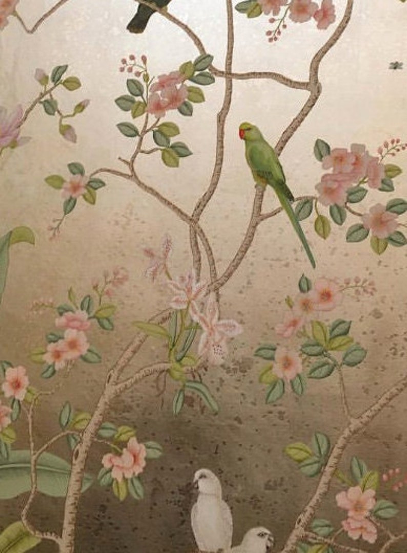 May include: A decorative wallpaper design featuring birds and floral branches. The image showcases a green parrot with a red beak perched on a branch, surrounded by pink blossoms and white birds against a gold background.