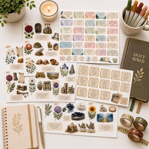 May include: A collection of stationery items including stickers, a notebook, pens, and washi tape. The stickers feature floral and biblical illustrations. A hardcover Holy Bible and a lit candle are also present.