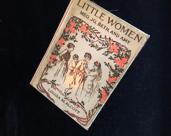 May include: A vintage book cover for "Little Women" by Louisa M. Alcott. The cover features an illustration of four girls in a garden setting with a floral border.