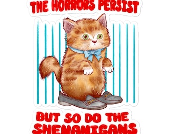 May include: A sticker showing an orange tabby cat wearing grey loafers and a blue bow tie. The text "THE HORRORS PERSIST" is above the cat, and "BUT SO DO THE SHENANIGANS" is below. The background has vertical blue stripes.