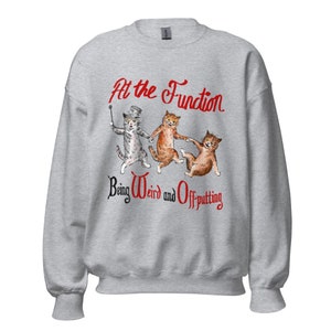 Op de afbeelding: Een lichtgrijs sweatshirt met een grillige illustratie van drie katten. De katten worden afgebeeld in een speelse pose, met één kat die een wandelstok en hoge hoed vasthoudt. De tekst "At the Function Being Weird and Off-putting" is rood gedrukt.