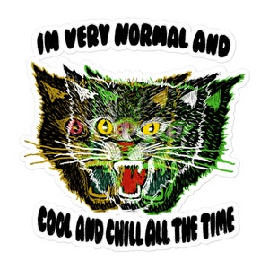 May include: A black and green cartoon cat with a wide open mouth and sharp teeth. The cat has a green and yellow striped pattern on its face. The text "I'm very normal and cool and chill all the time" is written around the cat.
