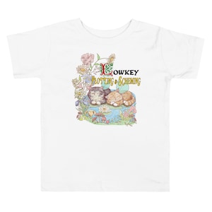May include: White t-shirt with a colorful illustration of two cats sleeping on a lily pad in a pond. The text "Lowkey Plotting & Scheming" is above the cats.