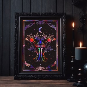 May include: A black framed print with a holographic iridescent design of a moth with a crescent moon and stars on a black background.