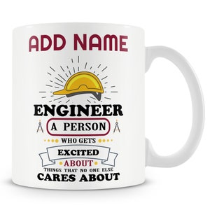May include: White ceramic mug with a red and black design. The mug features a yellow hard hat, a compass, and the text "ADD NAME ENGINEER A PERSON WHO GETS EXCITED ABOUT THINGS THAT NO ONE ELSE CARES ABOUT".