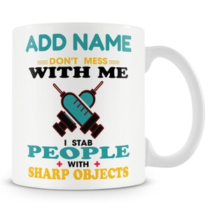 May include: White ceramic mug with a blue and yellow design. The mug says "ADD NAME DON'T MESS WITH ME I STAB PEOPLE WITH SHARP OBJECTS".
