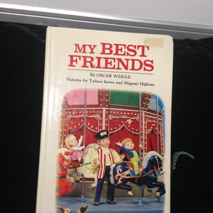 May include: A vintage children's book titled "My Best Friends" by Oscar Weigle. The cover features a colorful illustration of a carousel with puppets riding the horses. The book is a preschool puppet book.
