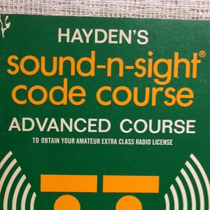 May include: A green book titled "Hayden's Sound-N-Sight Code Course: Advanced Course" with the subtitle "To Obtain Your Amateur Extra Class Radio License". The cover features a stylized illustration of Morse code signals and the authors' names, Lewis Robins and Reed Harris.