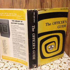 May include: The Officer's Guide book cover, a black and yellow design with a spiral pattern and a black and white illustration of a military cap. The book is from the 1965-1966 edition and is part of the Stackpole Books Library of Military Classics.