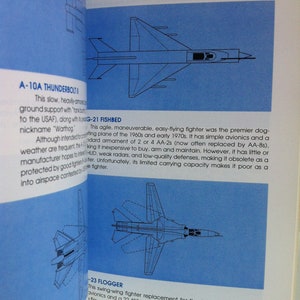 May include: A page from a book about military aircraft. The page features illustrations of three fighter jets: the A-10A Thunderbolt II, the MiG-21 Fishbed, and the MiG-23 Flogger. The text describes the capabilities and limitations of each aircraft.