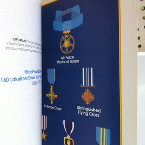 May include: A blue background with illustrations of different military medals, including the Air Force Medal of Honor, Air Force Cross, Distinguished Flying Cross, Purple Heart, and Airman's Medal. The text "IMPORTANT: The preceding warning...product has been damaged by unauthorized attempt to modify it." is visible at the top left corner of the image.