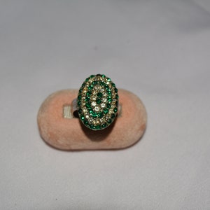vintage silver tone oval cluster ring with alternating rows of round white and green rhinestones, size 7  **M10