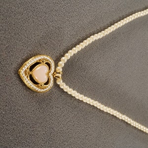 vintage gold tone and faux pearl strung bead necklace with heart shaped enhancer with pink heart stone, 18 inches, screw closure  **M3