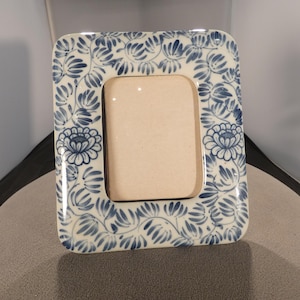 May include: A set of three ceramic mugs with a speckled, matte finish. The mugs are in shades of cream, light gray, and dark gray. Each mug has a simple, minimalist design, perfect for coffee or tea.