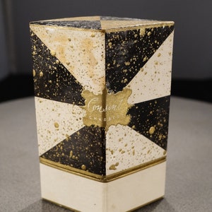 May include: A black and white box with gold accents and a gold splatter pattern. The box has the text "Consent Charbert" on the front.