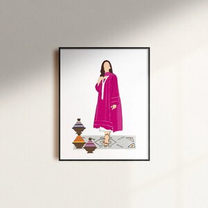 May include: A framed art print featuring a woman in a magenta dress and scarf, standing on a patterned rug. Decorative pottery in shades of brown, orange, and purple are in the foreground. The artwork is set against a white background.