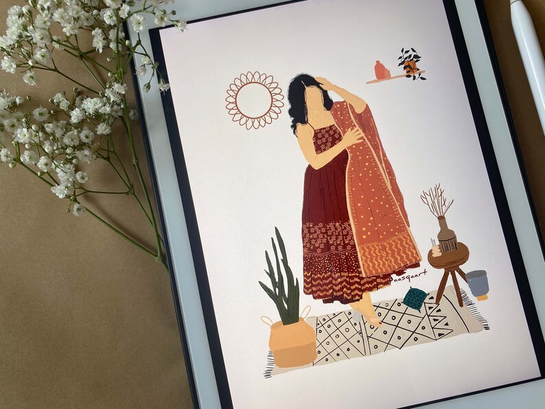 May include: Digital illustration of a woman in a maroon dress and shawl, standing on a patterned rug. The artwork includes a sun-shaped design, potted plants, and decorative items, all rendered in warm, earthy tones. A tablet displays the artwork.