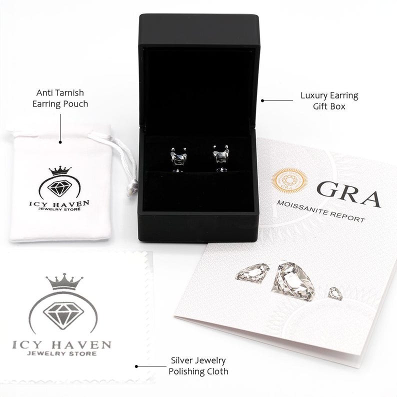 May include: A set of silver earrings with a square-shaped clear gemstone in a black gift box. The earrings come with a jewelry pouch, a polishing cloth, and a moissanite report.