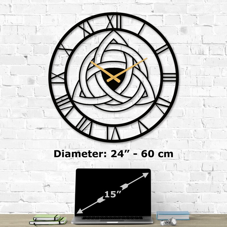 Size guide infographic for Metal Wall Clock with Triquetra design on a white brick wall. Image text shows 'Diameter:  24 inch - 60 cm' compared to a 15-inch laptop on a desk.