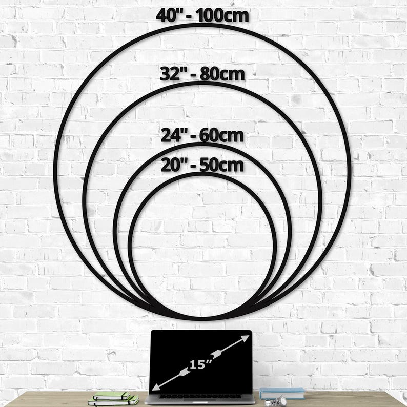 Wall clock size chart showing multiple dimensions of 20 inch, 24 inch, 32 inch, and 40 inch diameters compared to a 15 inch laptop, clear sizing guide for large metal wall clocks on a white brick wall backdrop for easy home decor planning.
