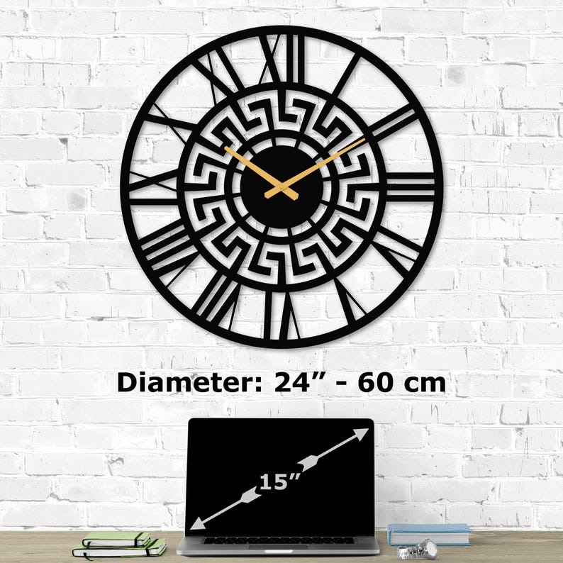 Size guide infographic for Metal Wall Clock with a Flower of Life design on a white brick wall. Image text shows 'Diameter:  24 inch - 60 cm' compared to a 15-inch laptop on a desk. Sacred Geometry Decor by Degary.