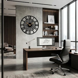 Large Meander metal wall clock featuring an ancient Greek key pattern, modern black steel wall art decor hanging in a professional executive office.