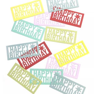 May include: Assortment of colourful paper cutouts with the words "Happy Birthday" in a white font. The cutouts are in various colours, including yellow, red, green, blue, and pink.