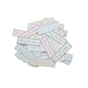 May include: A collection of rectangular gift tags, each bearing the words "Merry Christmas" in a handwritten font. The tags feature borders in various colours, such as red, blue, and yellow, set against a white backdrop.