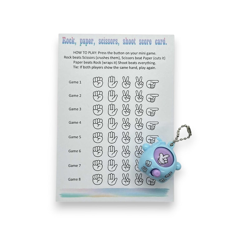 May include: A score card for the game Rock, Paper, Scissors, Shoot, with a light blue mini game. The card has game results and instructions. The mini game is light blue with a silver keychain.