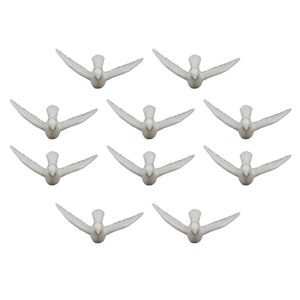 May include: Set of ten white dove wall decorations. The doves are in a flying position with their wings spread out.