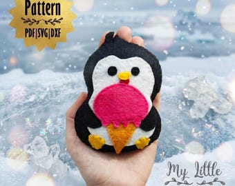 May include: A handmade felt penguin holding a pink ice cream cone. The penguin is black, white, and yellow, with the text "Pattern PDF|SVG|DXF" in a gold starburst. The design is by My Little Art Designs.