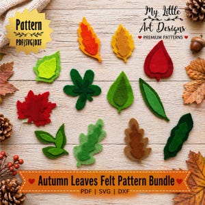 Puede incluir: Un conjunto de hojas de fieltro coloridas en varias formas y tamaños, incluyendo rojo, naranja, amarillo y verde. La imagen incluye el texto "Autumn Leaves Felt Pattern Bundle" y "PDF | SVG | DXXF". Las hojas están dispuestas sobre una superficie de madera clara.