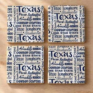 May include: A set of four square coasters with a cream background and dark blue text featuring Texas-themed words including Texas, Longhorn, Bluebonnet, Pecan, Mockingbird, Armadillo, Rodeos, Cowboy Culture, Lone Star State, oil, and December 29, 1845.