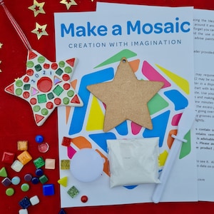 May include: A mosaic craft kit with a star-shaped ornament. The kit contains a wooden star, colourful tiles, grout, and instructions. The finished ornament is decorated with red, green, and white tiles, and the year 2021.