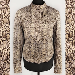 May include: A brown and gold snakeskin patterned jacket with a stand-up collar and long sleeves.