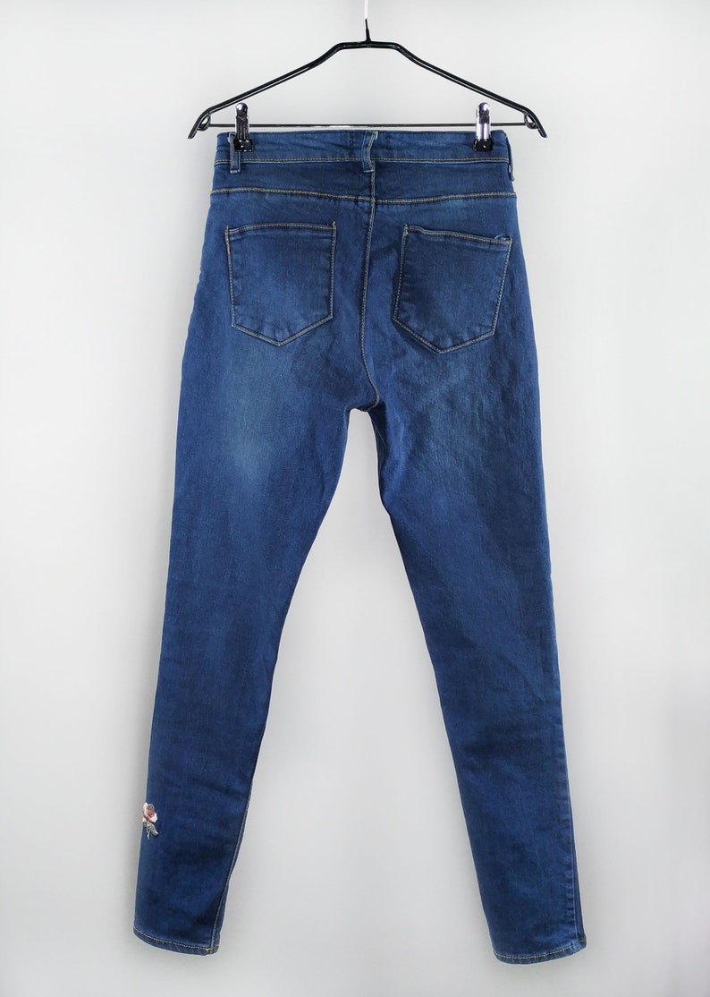Vintage blue jeans with floral embroidery