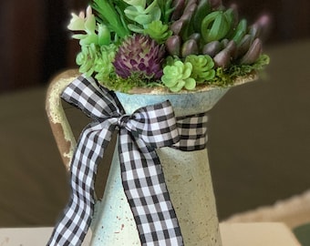 Stunning Artificial Succulent Arrangement in Rustic Metal Pitcher. Overall approx dimensions:  6”L x 4”W x 11”H