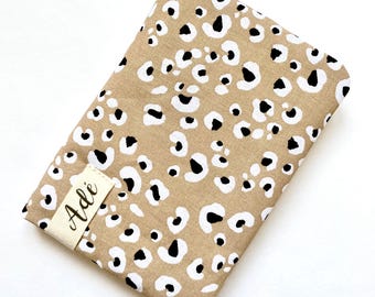 Personalized passport holder printed with Graou leopard on a sand background